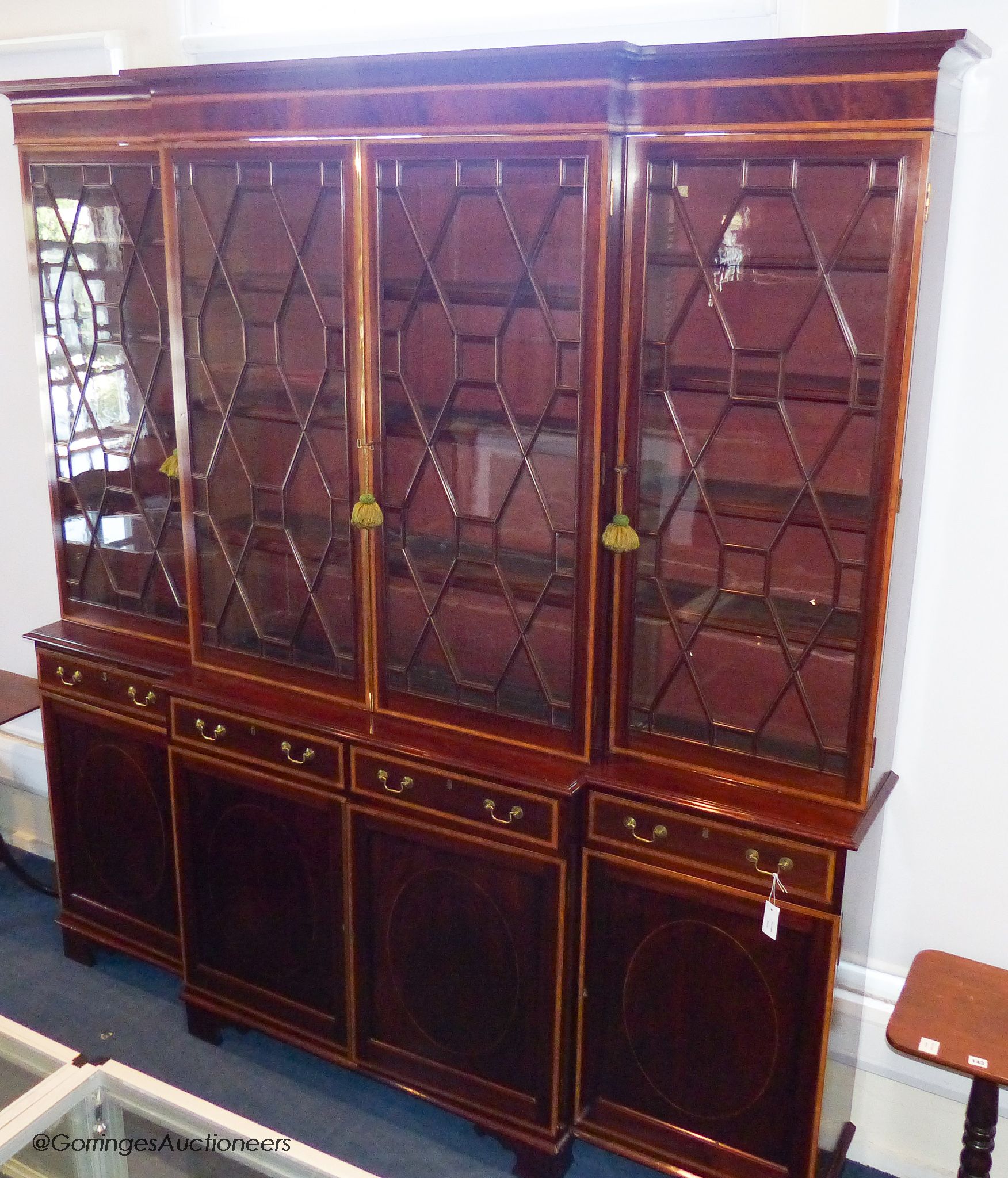 A 19th century and later satinwood banded mahogany breakfront bookcase, 241.5 cm high, approximately 230 cm wide, 42 cm deep